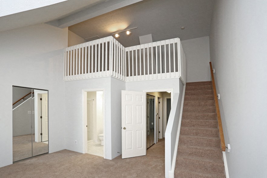 a view of a stairwell in a house with a white staircase