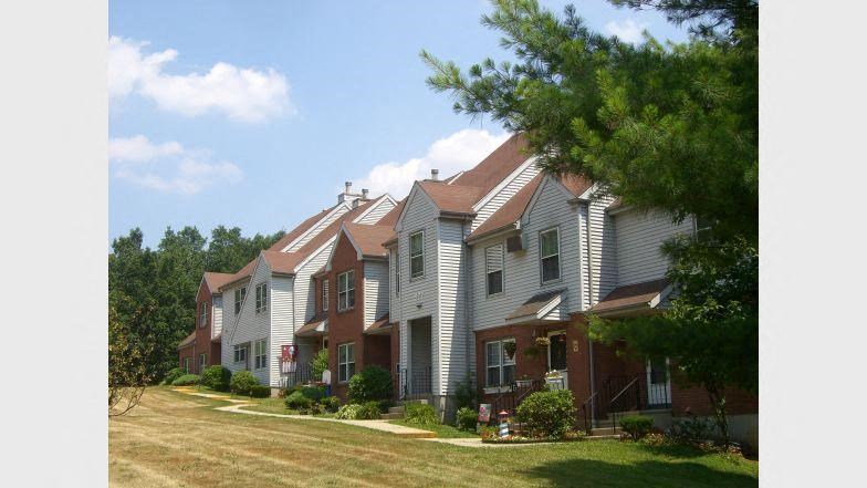 a row of houses on the side of a field