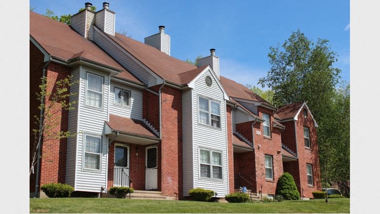 a red brick house with white siding