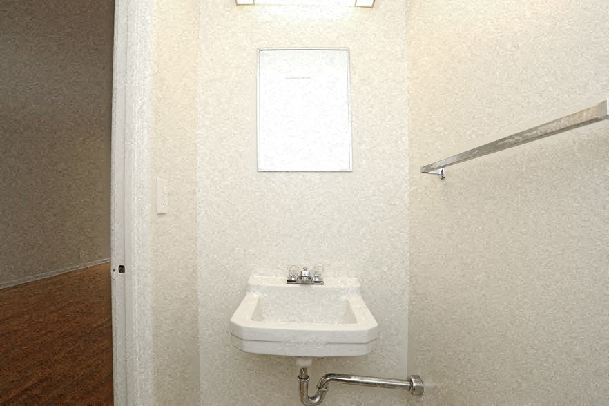 a small bathroom with a sink and a mirror