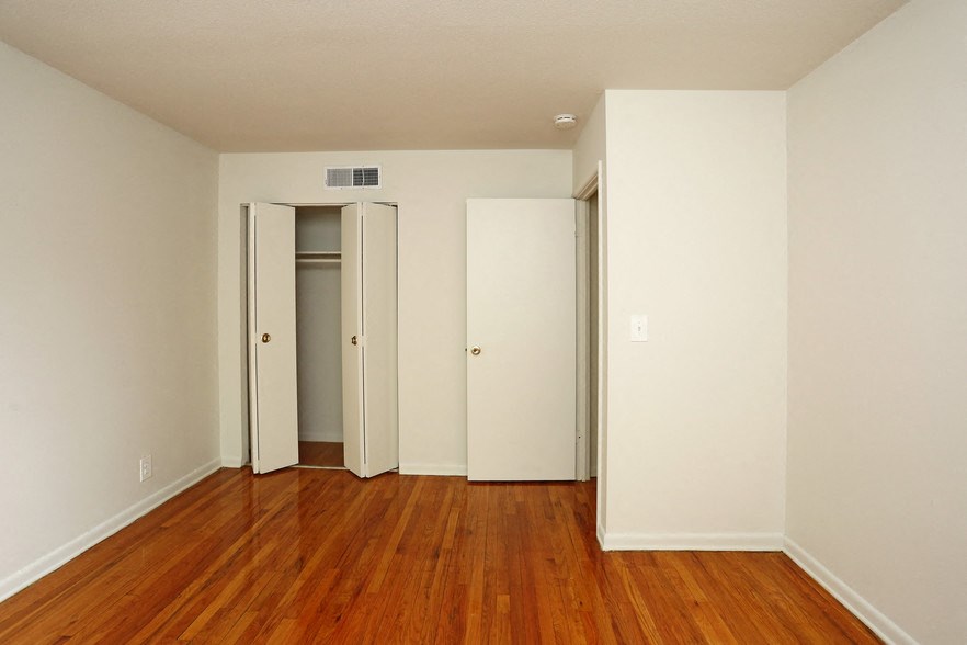 a living room with wood floors and white walls