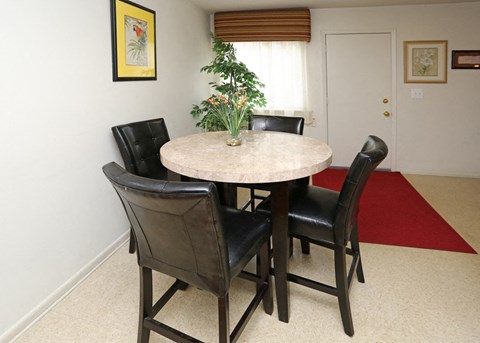 a dining room with a table and chairs