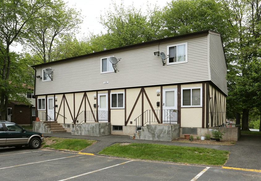 the side of a building with a car in a parking lot