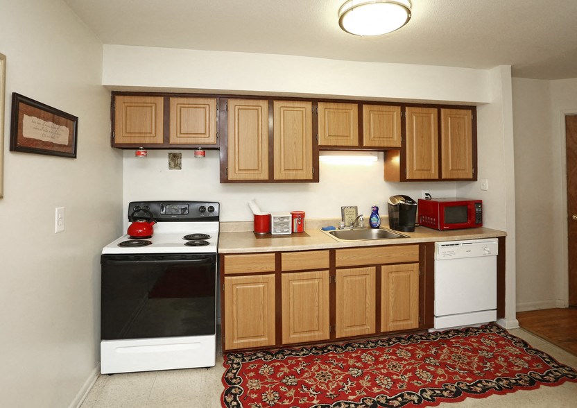 a small kitchen with a stove sink and refrigerator