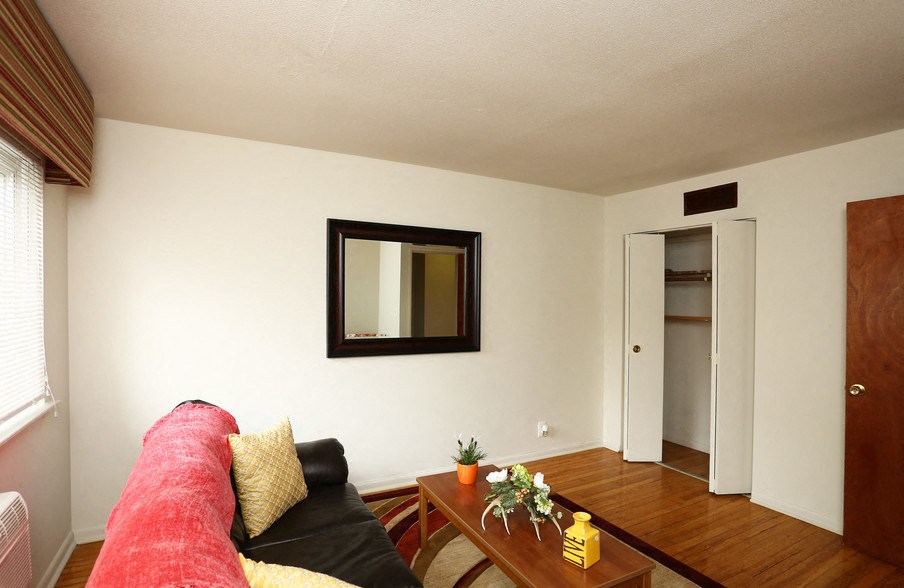 a living room with a couch and a mirror