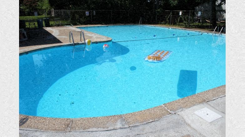 a large swimming pool with a blue water