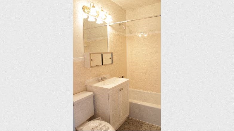 a white bathroom with a sink and a mirror