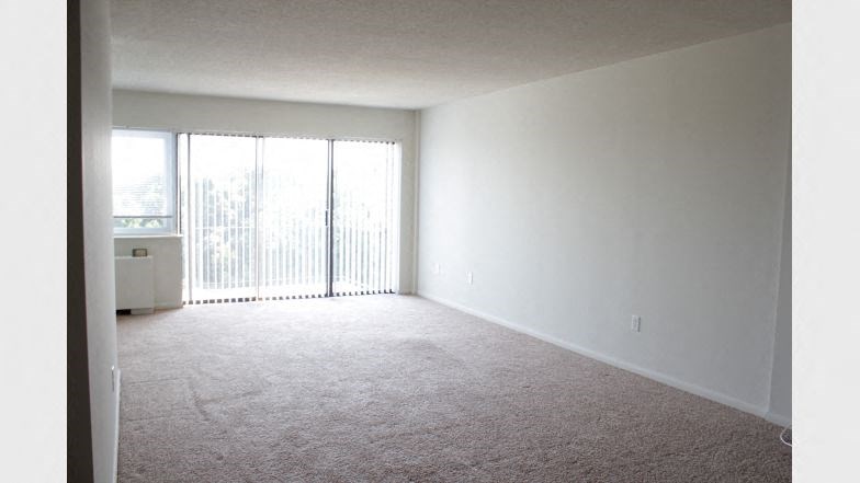 an empty living room with a large window