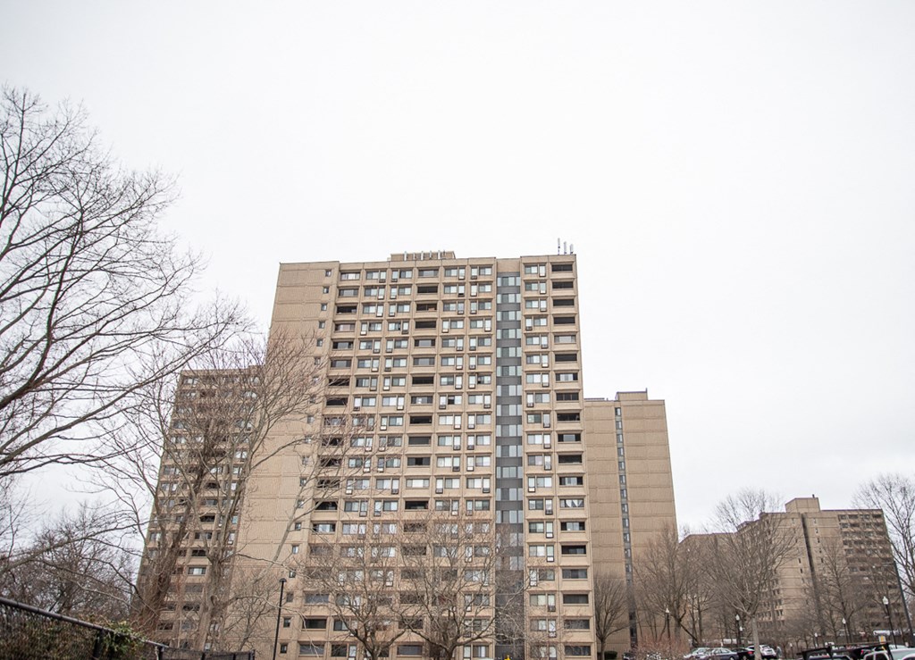 a tall building with many balconies in a city