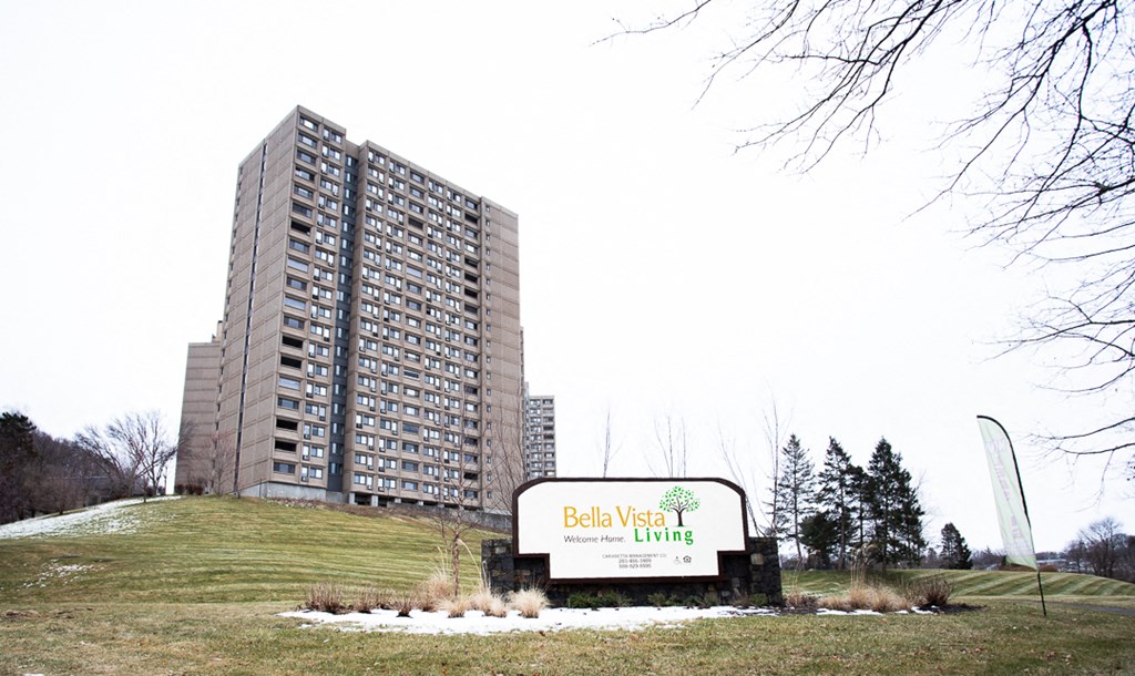 a sign living in front of a tall building