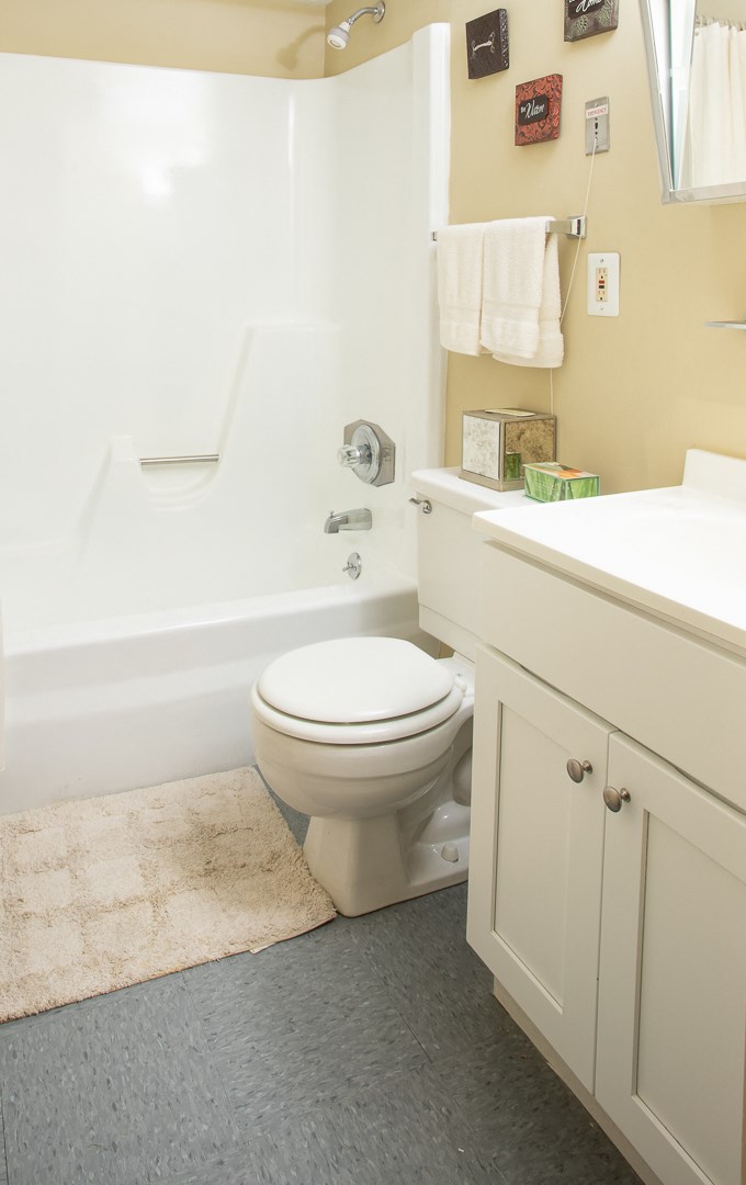 a bathroom with a toilet and a tub and a sink