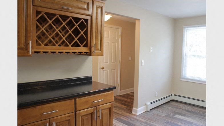 a kitchen with a wine cabinet and a door