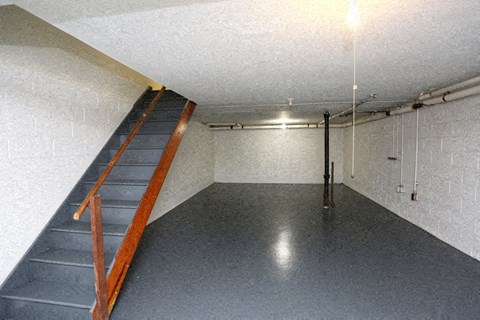 a large empty basement with a ladder in it