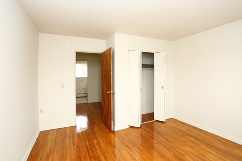 an empty room with wooden floors and a door