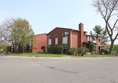 a red brick building with a street in front of it