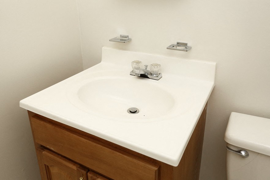 a bathroom with a white sink and a toilet