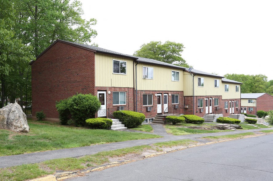 a row of houses with a street in front of them