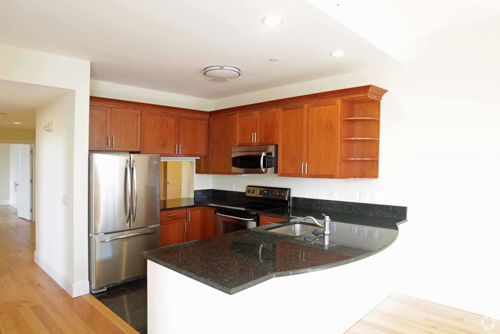 a kitchen with granite counter top and stainless steel appliances