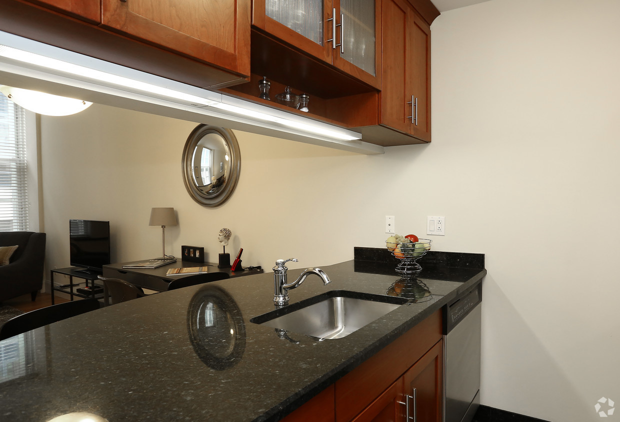 a kitchen with granite counter top and a sink