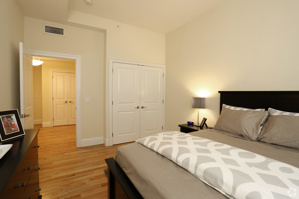 a bedroom with a large bed and a door to a bathroom