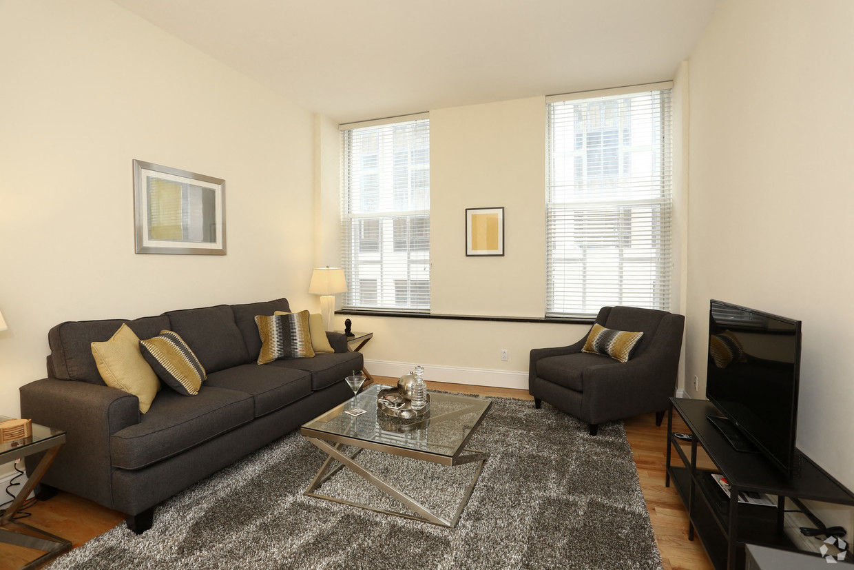 a living room with two couches and a coffee table and a television