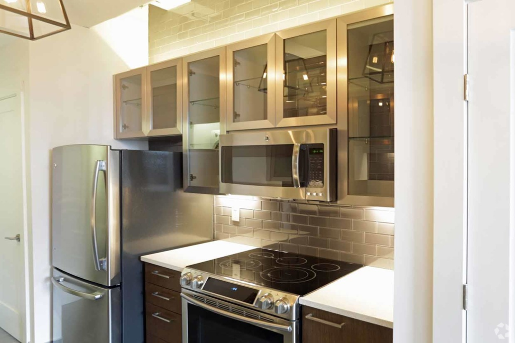 a kitchen with stainless steel appliances and wooden cabinets