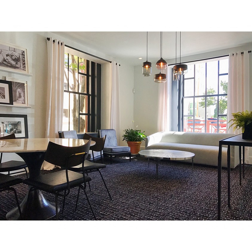 a living room with a couch and a table and chairs