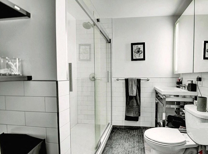 a bathroom with a toilet and a shower