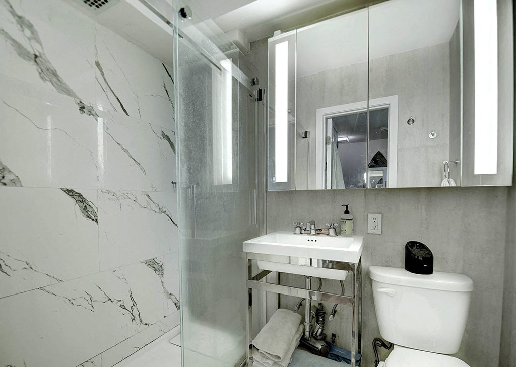 a bathroom with a sink and a toilet and a mirror