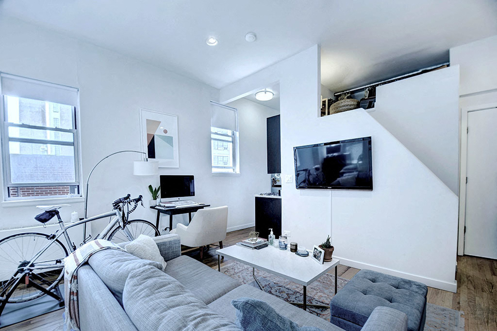 a living room with a couch and a bike