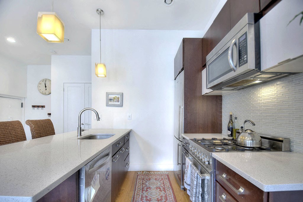 a kitchen with a sink and a stove and a microwave