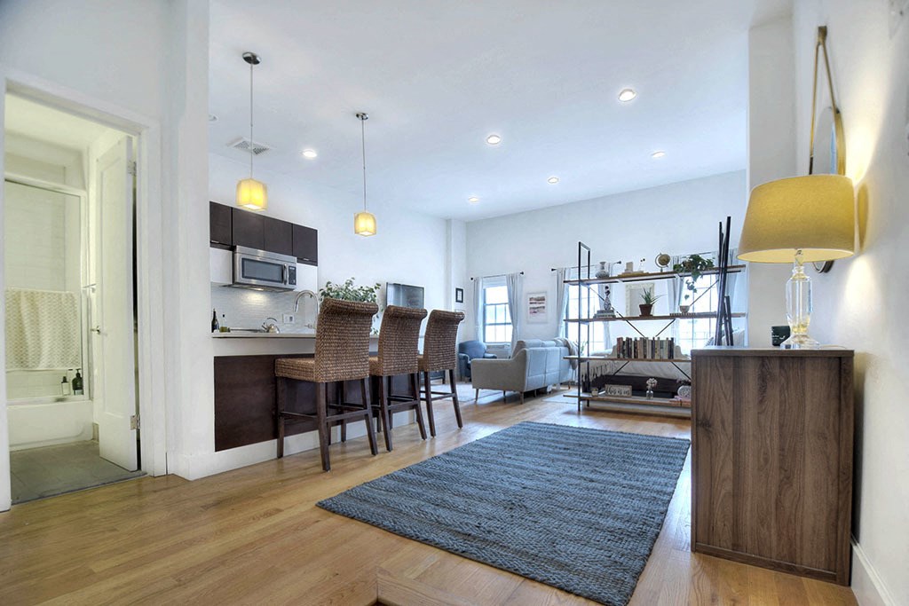a living room with a kitchen and a dining room