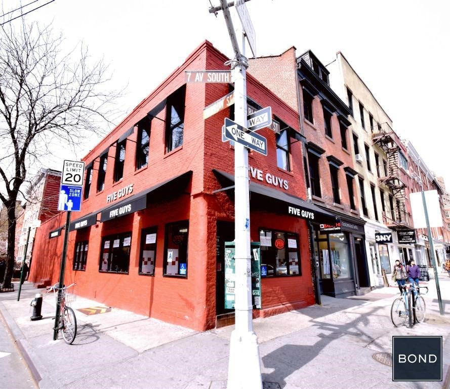 a red building on the corner of a city street