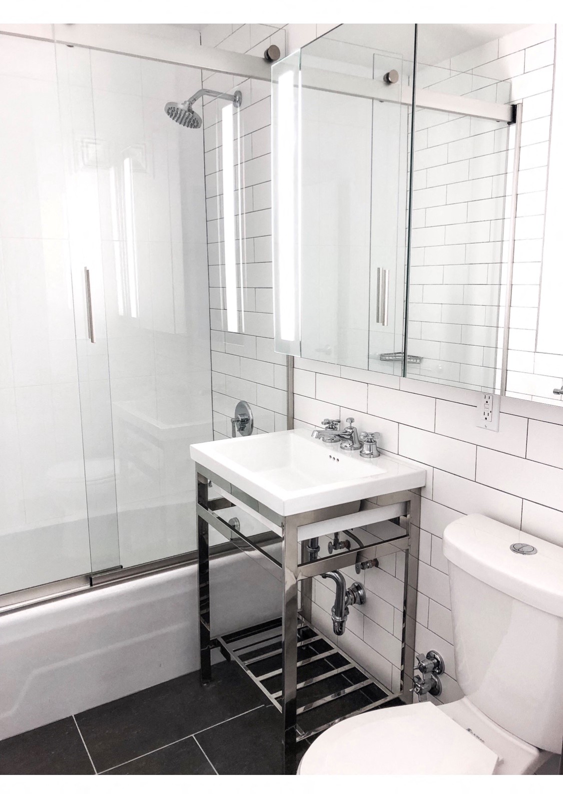 a bathroom with a sink and a shower and a toilet