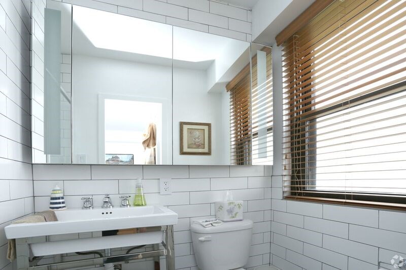 a white bathroom with a sink and a mirror
