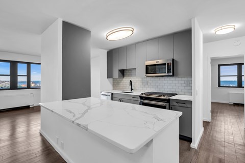 A modern kitchen with a large island in the center.