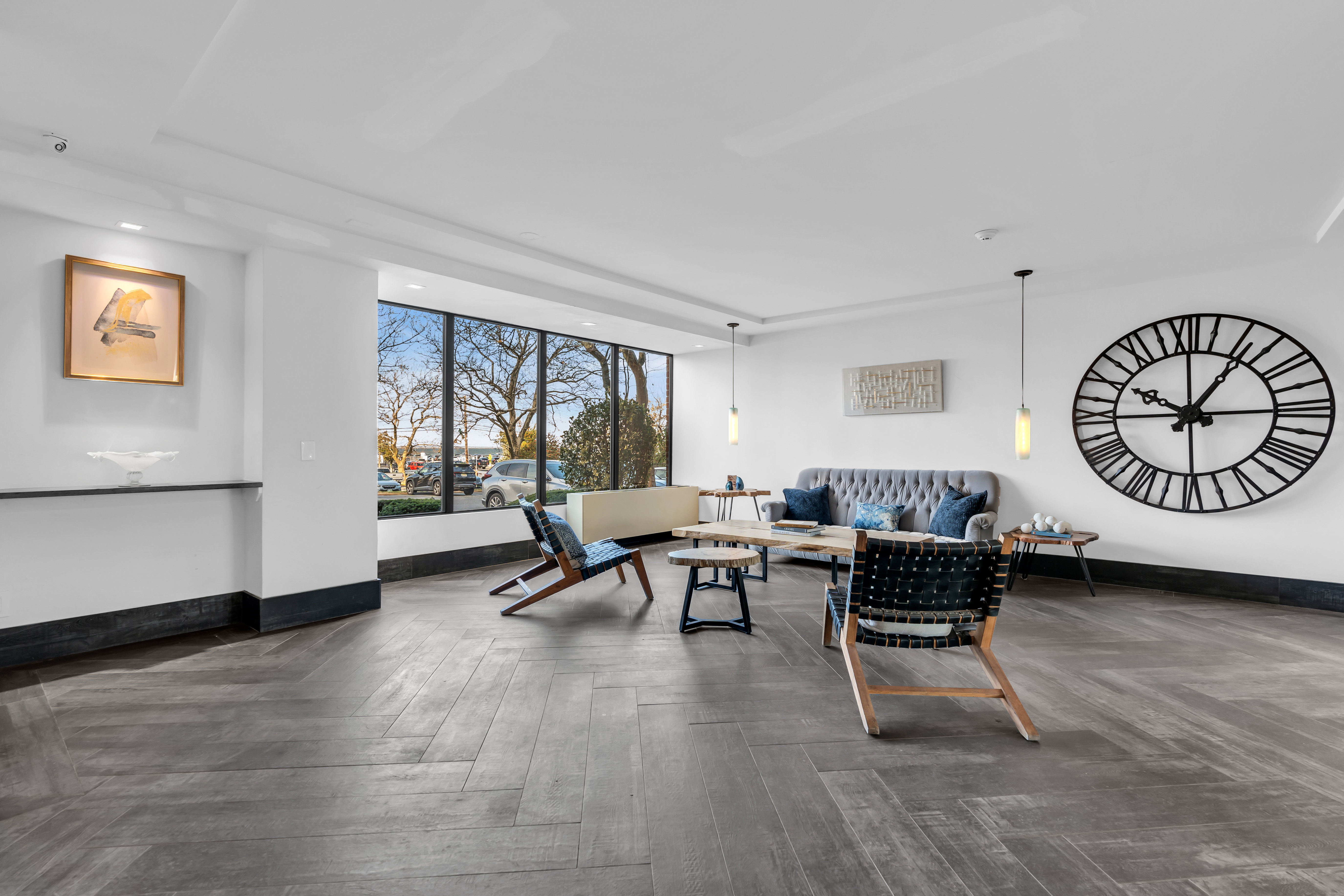 A living room with a large clock on the wall.