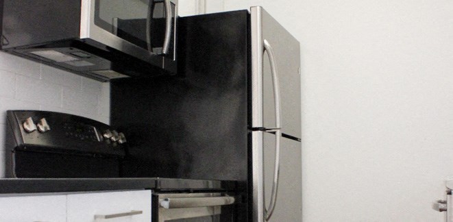 a kitchen with a refrigerator and a microwave