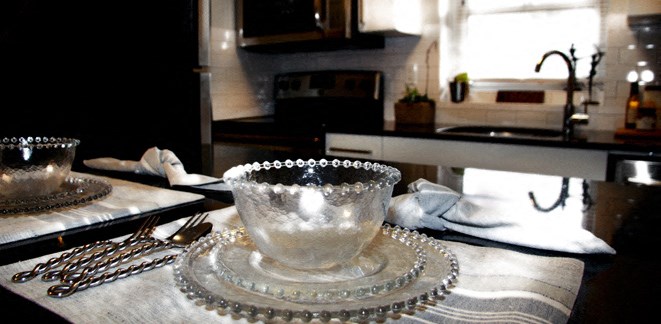 a glass bowl sitting on a plate on a table