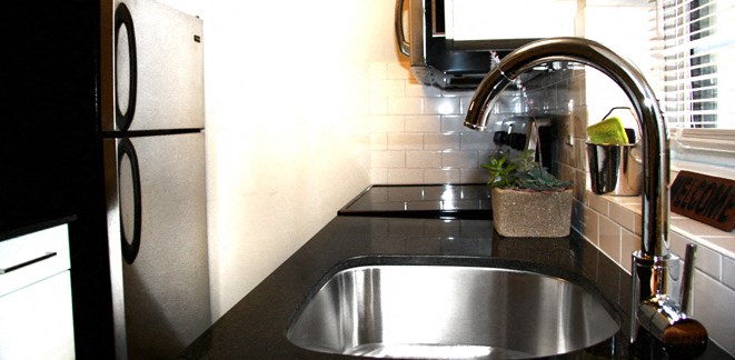 a kitchen with a sink and a refrigerator