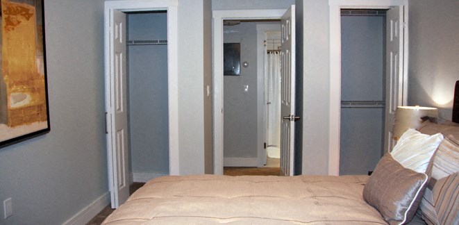 a bedroom with a bed and a closet