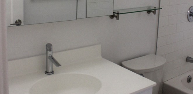 a white bathroom with a sink and a toilet