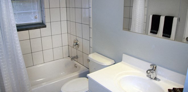 a bathroom with a sink toilet and a bath tub