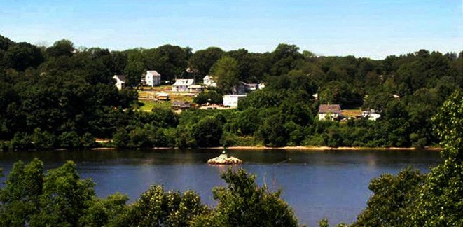 a small boat in the water near a body of water