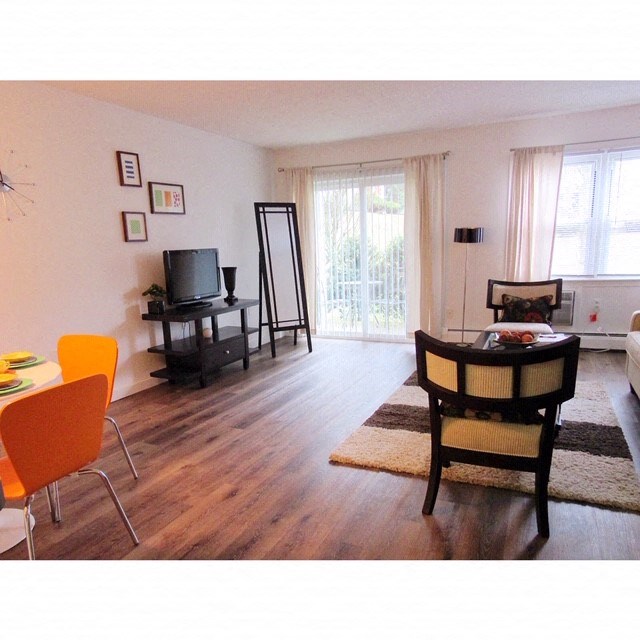 a living room with a table and chairs and a television