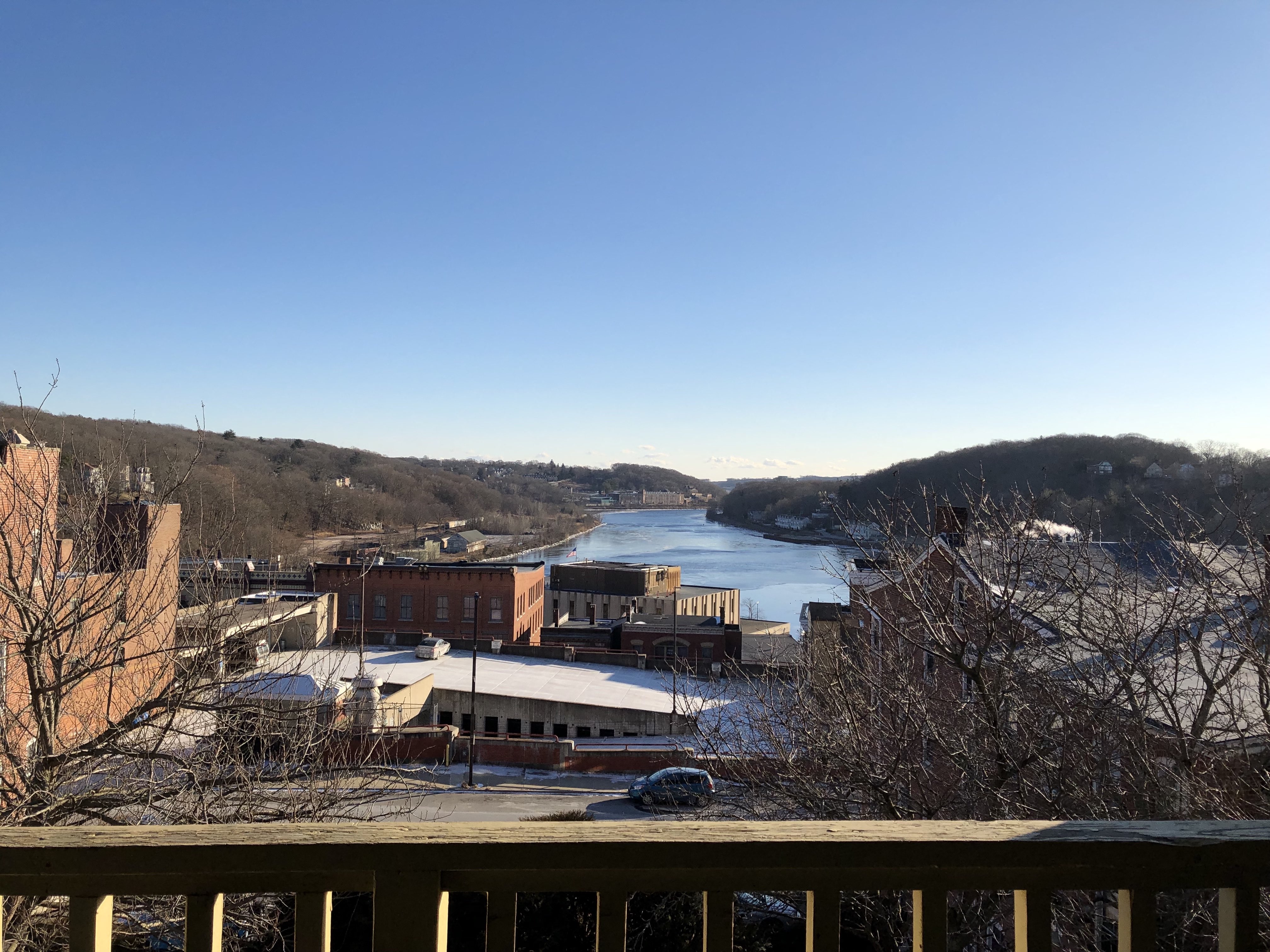 a view of a river from a balcony overlooking a city and a river valley