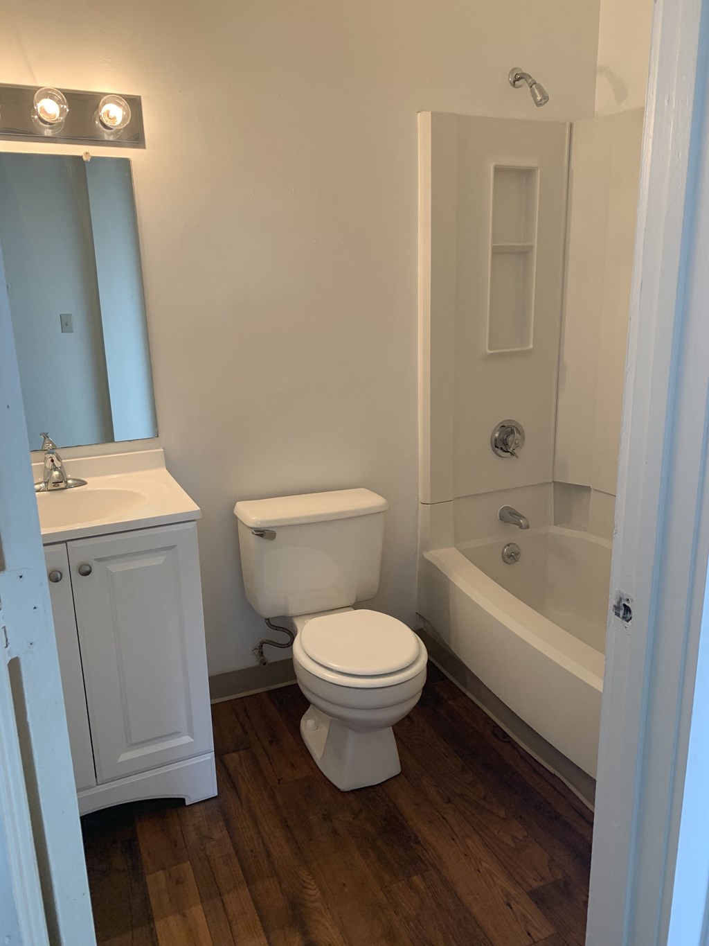 a bathroom with a toilet and a tub and a sink