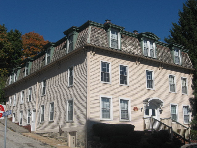 a large white house with a roof and windows