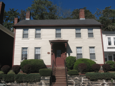 a large white house with a red door