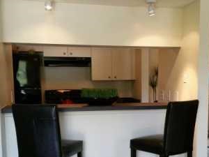 Kitchen with breakfast nook and separate dining area | L'Estancia Apartments